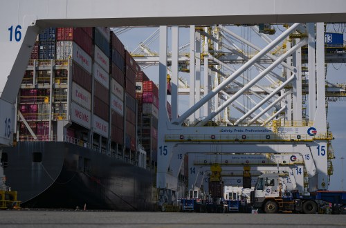 Containers are unloaded from the Yang Ming Throne container ship at Deltaport, at Roberts Bank in Delta, B.C., on Thursday, July 16, 2026. THE CANADIAN PRESS/Darryl Dyck