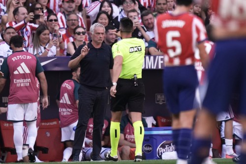Real Madrid's head coach Jose Mourinho speaks to Referee Miguel Angel Ortiz Arias during a Spanish La Liga soccer match between Atletico Madrid and Real Madrid in Madrid, Sunday, Sept. 20, 2026. (AP Photo/Bernat Armangue)