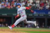 Toronto Blue Jays' Kazuma Okamoto, of Japan, rounds first base after hitting a single, scoring teammate Brett Bateman, during the fifth inning of a baseball game against the Texas Rangers, Sunday, Sept. 20, 2026, in Arlington, Texas. (AP Photo/LM Otero)