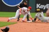 Cleveland Guardians' Travis Bazzana, front left, tags out Athletics' Lawrence Butler (4) on a steal-attempt as umpire Junior Valentine, back left, watches during the seventh inning of a baseball game, Sunday, Sept. 20, 2026, in Cleveland. (AP Photo/Phil Long)