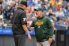Athletics manager Mark Kotsay, right, argues a call at first base with umpire Jordan Baker, left, during the fourth inning of a baseball game against the Cleveland Guardians, Sunday, Sept. 20, 2026, in Cleveland. (AP Photo/Phil Long)
