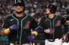 Arizona Diamondbacks' Gabriel Moreno, left, and Nolan Arenado, right, run back toward the dugout after scoring on Arenado's grand slam in the fifth inning of a baseball game against the New York Yankees, Sunday, Sept. 20, 2026, in Phoenix. (AP Photo/Caitlin O'Hara)