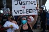 People speak during a demonstration where a man was shot in his vehicle by an ICE officer, Sunday, Sept. 20, 2026, in Austin, Texas. (AP Photo/Joel Angel Juarez)