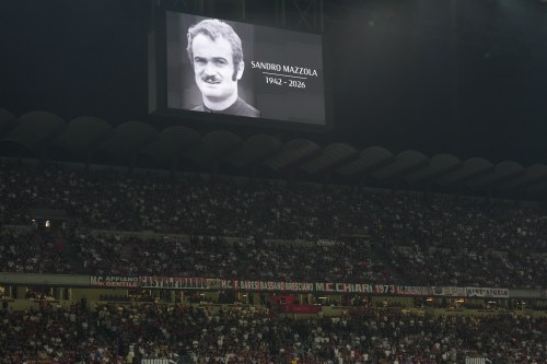 A portrait of late Sandro Mazzola is displayed moment of silence before the Serie A soccer match between AC Milan and Lecce, in Milan, Italy, Sunday, Sept. 20, 2026. (AP Photo/Antonio Calanni)