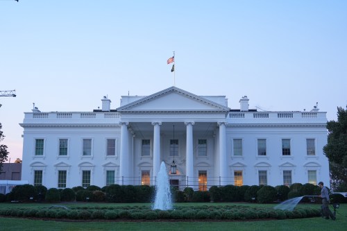 A worker waters plants on the North Lawn of the White House Monday, Sept. 21, 2026, in Washington. (AP Photo/Mark Schiefelbein)