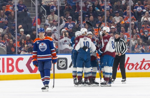 Colorado Avalanche celebrate a goal as Edmonton Oilers' Evan Bouchard (2) skates past during second period NHL action, in Edmonton on Monday, April 13, 2026. THE CANADIAN PRESS/Jason Franson