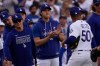 Los Angeles Dodgers' Mookie Betts, right, is congratulated by Shohei Ohtani, center, and Yoshinobu Yamamoto after the Dodgers defeated the San Francisco Giants in a baseball game Sunday, Sept. 20, 2026, in Los Angeles. (AP Photo/Mark J. Terrill)