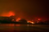 The Bald Range wildfire, in the south Okanagan region, burns in Summerland, B.C., late Saturday, Aug. 8, 2026. RCMP say a multi-agency investigation into the origins of the destructive blaze continues. THE CANADIAN PRESS/Darryl Dyck