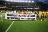 Players of Atletico Morelia and Leones Negros hold a sign that reads, 