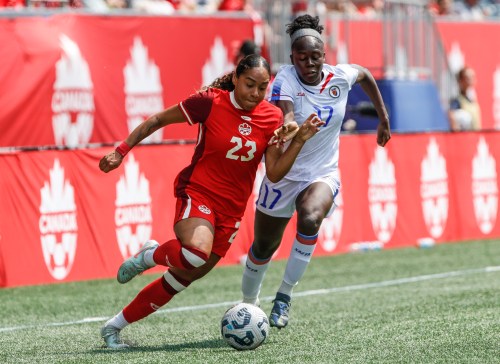 Canada's Olivia Smith (23) makes her way around Haiti's Chelsea Domond (17) during second half soccer action in Winnipeg, Saturday, May 31, 2025. THE CANADIAN PRESS/John Woods