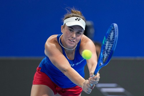 Linda Noskova of Czech Republic returns the ball to Katie Boulter of Britain in a quarterfinal match for the Billie Jean King Cup held in Shenzhen in southern China's Guangdong province, Tuesday, Sept. 22, 2026. (AP Photo/Andy Wong)