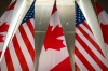 U.S. and Canadian flags are displayed before an event with Ontario Premier Doug Ford and the U.S. Chamber of Commerce, Tuesday, Feb. 11, 2025, in Washington. (AP Photo/Mark Schiefelbein).