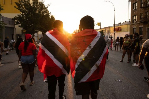 FILE - People with Trinidad and Tobago flag are seen during J'ouvert celebration, Sept. 4, 2023, in the Brooklyn borough of New York. (AP Photo/Yuki Iwamura, File)