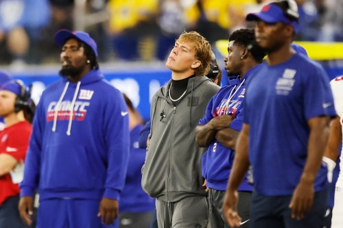 New York Giants quarterback Jaxson Dart, center, watches from the sideline during the second half of an NFL football game against the Los Angeles Rams in Inglewood, Calif., Monday, Sept. 21, 2026. (AP Photo/Caroline Brehman)