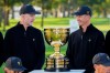 International team captain Geoff Ogilvy, of Australia, left, and player Adam Scott, of Australia, look at the Presidents Cup trophy during a team portrait prior to the start of the Presidents Cup golf tournament against the USA team at Medinah Country Club, Wednesday, Sept. 23, 2026, in Medinah, Ill. (AP Photo/Matt Slocum)