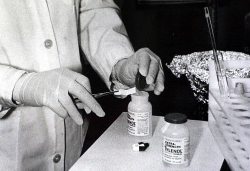 FILE - Bottles of Extra-Strength Tylenol are tested with a chemically treated paper that turns blue in the presence of cyanide at the Illinois Department of Health in Oct. 1982, in Chicago. (AP Photo/John Swart, File)