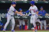 New York Mets' Marcus Semien (10) is congratulated by third base coach Jacob Latz as Semien runs the bases on a solo home run during the eighth inning of a baseball game against the Texas Rangers, Wednesday, Sept. 23, 2026, in Arlington, Texas. (AP Photo/LM Otero)