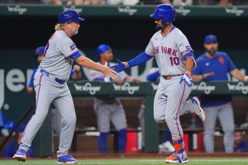 New York Mets' Marcus Semien (10) is congratulated by third base coach Jacob Latz as Semien runs the bases on a solo home run during the eighth inning of a baseball game against the Texas Rangers, Wednesday, Sept. 23, 2026, in Arlington, Texas. (AP Photo/LM Otero)