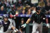 Arizona Diamondbacks' Corbin Carroll, right, breaks from the batter's box after connecting for a triple to drive in two runs as Colorado Rockies catcher Hunter Goodman looks on in the first inning of a baseball game Wednesday, Sept. 23, 2026, in Denver. (AP Photo/David Zalubowski)