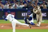 San Diego Padres' Manny Machado, right, hits a two-run home run as Los Angeles Dodgers starting pitcher Yoshinobu Yamamoto, left, and catcher Will Smith watch during the fourth inning of a baseball game Wednesday, Sept. 23, 2026, in Los Angeles. (AP Photo/Mark J. Terrill)