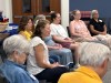 In this photo provided by Religion News Service, Rabbi Jenny Solomon, center left, leads a short mindfulness meditation before teaching a class on Jewish ethics Monday, Sept. 14, 2026, at Beth Meyer Synagogue in Raleigh, N.C. (Yonat Shimron/Religion News Service via AP)