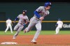 New York Mets' Carson Benge, front, and Marcus Semien (10) round third as the two score on a Francisco Alvarez double in the sixth inning of a baseball game against the Texas Rangers Tuesday, Sept. 22, 2026, in Arlington, Texas. (AP Photo/Tony Gutierrez)