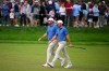 USA teams' Scottie Scheffler and Sam Burns, right, walk up the first fairway during the first round four-ball match at the Presidents Cup golf tournament against the International team at Medinah Country Club, Thursday, Sept. 24, 2026, in Medinah, Ill. (AP Photo/Matt Slocum)