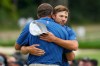 USA teams' Scottie Scheffler embraces Sam Burns after their match against International teams' Min Woo Lee, of Australia, and Sungjae Im, of South Korea, after the first round four-ball match at the Presidents Cup golf tournament at Medinah Country Club, Thursday, Sept. 24, 2026, in Medinah, Ill. (AP Photo/Chris Carlson)
