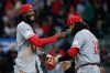 Cincinnati Reds' Elly De La Cruz, left, and Eugenio Suárez (28) celebrate after defeating the Atlanta Braves during the ninth inning of a baseball game, Tuesday, Sept. 22, 2026, in Atlanta. (AP Photo/Erik S. Lesser)