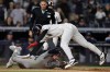 New York Yankees' George Lombard Jr. avoids a tag from Tampa Bay Rays catcher Liam Hicks to score a run during the seventh inning of a baseball game Thursday, Sept. 24, 2026, in New York. (AP Photo/Adam Hunger)