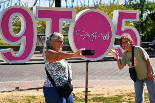 Wendy Delehanty, left, and Nancy Beaty of Jew Jersey pose with a sign during Dolly Parton Day honoring the late country music artist, Friday, Sept. 25, 2026, in Nashville, Tenn. (AP Photo/George Walker IV)