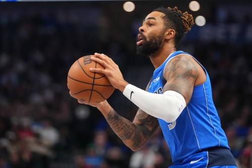 FILE - Dallas Mavericks guard D'Angelo Russell (5) prepares to shoot during the first half of an NBA basketball game between the Dallas Mavericks and the Miami Heat Wednesday, Dec. 3, 2025, in Dallas. (AP Photo/Julio Cortez,File)