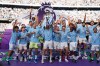 FILE - Manchester City players celebrate with the Premier League trophy after the English Premier League soccer match between Manchester City and West Ham United in Manchester, England, Sunday, May 19, 2024. (AP Photo/Dave Thompson, File)