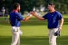 USA teams' Chris Gotterup, right, celebrates with Cameron Young after defeating the International team after their Presidents Cup golf tournament third round foursome match at Medinah Country Club, Saturday, Sept. 26, 2026, in Medinah, Ill. (AP Photo/Matt Slocum)
