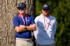 USA team captain Brandt Snedeker, left, and assistant Keegan Bradley watch play on the 12th green against the International team during a Presidents Cup golf tournament third round four-ball match at Medinah Country Club, Saturday, Sept. 26, 2026, in Medinah, Ill. (AP Photo/Matt Slocum)