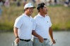 International teams' Tom Kim, of South Korea, laughs after Si Woo Kim, of South Korea, right, missed a putt on the 13th green against the USA team during a Presidents Cup golf tournament third round foursome match at Medinah Country Club, Saturday, Sept. 26, 2026, in Medinah, Ill. (AP Photo/Chris Carlson)