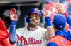 Philadelphia Phillies' Bryce Harper is cheered in the dugout after hitting a solo home run in the fifth inning of a baseball game against the Tampa Bay Rays, Sunday, Sept. 27, 2026, in Philadelphia. (AP Photo/Laurence Kesterson)