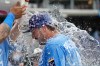 Kansas City Royals' Vinnie Pasquantino is doused by teammates after their baseball game against the Cleveland Guardians, Sunday, Sept. 27, 2026, in Kansas City, Mo. (AP Photo/Charlie Riedel)