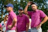 From left: USA teams' Sam Burns, Wyndham Clark and Scottie Scheffler watch plays on the 16th hole against the International team during a Presidents Cup golf tournament final round singles match at Medinah Country Club, Sunday, Sept. 27, 2026, in Medinah, Ill. (AP Photo/Chris Carlson)