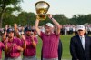 President Donald Trump, right, watches as USA team captain Brandt Snedeker holds the Presidents Cup trophy after the Presidents Cup golf tournament against the International team at Medinah Country Club, Sunday, Sept. 27, 2026, in Medinah, Ill. (AP Photo/Chris Carlson)
