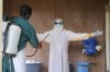 A health-care worker in protective clothing is disinfected by a colleague inside a treatment center for Ebola patients in Beni, North Kivu province, eastern Congo, Saturday, Sept. 26, 2026. (AP Photo/Sebastien Kitsa Musayi)