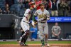 Athletics' Shea Langeliers, right, walks back to the dugout as Cleveland Guardians' Patrick Bailey, left, looks on after a strikeout by Cleveland Guardians relief pitcher Cade Smith for the final out of a baseball game, Sunday, Sept. 20, 2026, in Cleveland. (AP Photo/Phil Long)