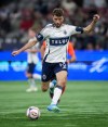 Vancouver Whitecaps' Thomas Muller takes a shot on goal during the second half of an MLS soccer match against Sporting Kansas City, in Vancouver, on Friday, April 17, 2026. THE CANADIAN PRESS/Darryl Dyck