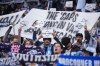 Vancouver Whitecaps fans hold up signs reading 