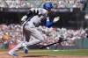 Los Angeles Dodgers designated hitter Shohei Ohtani runs to first base after hitting a single during the fifth inning of a baseball game against the San Francisco Giants, Saturday, Sept. 26, 2026, in San Francisco. (AP Photo/Jeff Chiu)