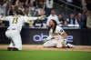 San Diego Padres Fernando Tatis Jr. reacts with third baseman Manny Machado (13) after scoring on a steal and an error by Chicago Cubs in the seventh inning of Game 1 of the National League Wild Card baseball playoff series Tuesday, Sept. 29, 2026, in San Diego. (AP Photo/Gregory Bull)