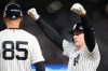 New York Yankees' Ben Rice, right, reacts next to first base coach Dan Fiorito, after collecting an RBI on a bases loaded single against the Boston Red Sox during the seventh inning in Game 1 of baseball's American League Wild Card Series, Tuesday, Sept. 29, 2026, in New York. (AP Photo/Yuki Iwamura)