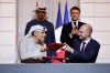 FILE -France's President Emmanuel Macron, rear right, and United Arab Emirates President Sheikh Mohamed bin Zayed Al Nahyan, rear left, look on as France's Minister for Europe and Foreign Affairs Jean-Noel Barrot, right, and CEO of Mubadala Investment Company Khaldoon Al Mubarak, left, sign an agreement on AI, at the Elysee Palace, in Paris, Feb. 6, 2025. (Ludovic Marin/Pool Photo via AP), File)