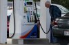A customer checks gas price while he fills up his vehicle's tank at a gas station in Racine, Wis., Tuesday, Sept. 22, 2026. (AP Photo/Nam Y. Huh)