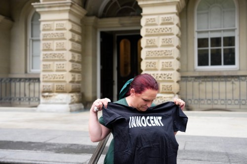 Jennifer Gaskin holds up a T-shirt given to her by a supporter from the Innocence Project, outside a Toronto Appeal Court on Tuesday, Sept. 29, 2026. THE CANADIAN PRESS/Chris Young
